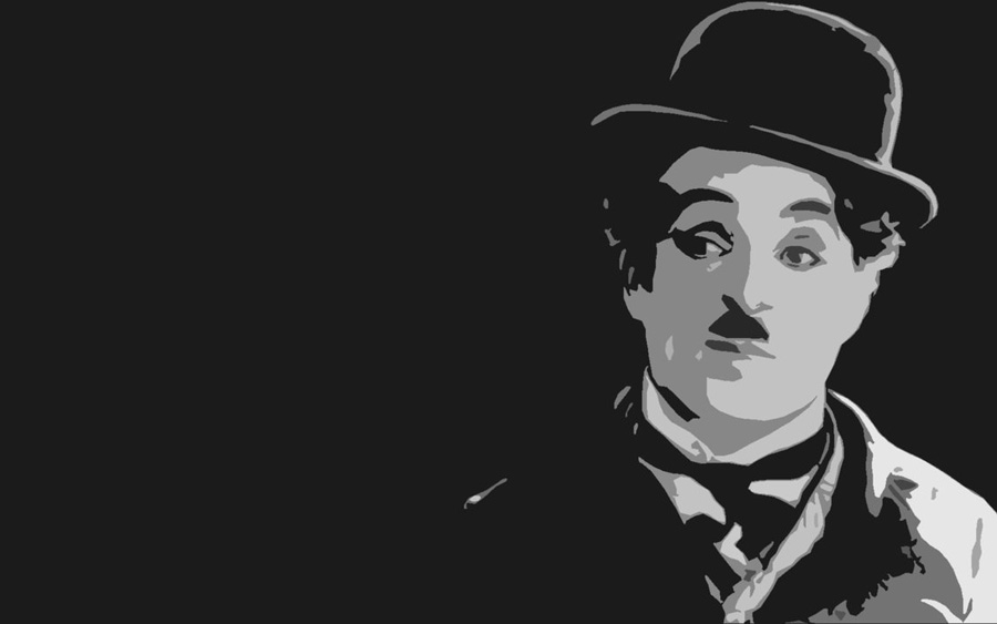 A black-and-white portrait of a man with a bowler hat and mustache.